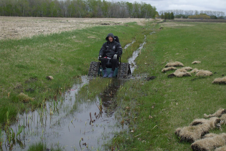 Tankchair Taking on a Muddy Ditch in Canada
